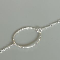 Sterling silver chain bracelet with an oval ring charm. Length: 6.8 to 7.8 inches Oval charm: 13 x 17 mm Weight: 1 gm This bracelet is made of 925 hypoallergenic sterling silver. Can be packaged in a gift box. I can include a personal message from you if needed You are welcome to contact me at... bhavnakwintra1956@gmail.com For more beautiful pieces from my shop, please browse 👇 TOE RINGS: https://www.etsy.com/your/shops/TheSilverGame/tools/listings/section:27020628,view:table EAR HOOPS: https: Silver Minimalist Bangle Charm Bracelet, Minimalist Silver Bangle Charm Bracelet, Simple Handmade Silver Bracelets, Silver Bracelets With Simple Design For Gift, Silver Bracelets Simple Design Gift, Silver Minimalist Bracelet With Lobster Clasp, Minimalist Silver Bracelet With Lobster Clasp, Minimalist Silver Chain Charm Bracelet, Silver Bracelets For Gifts