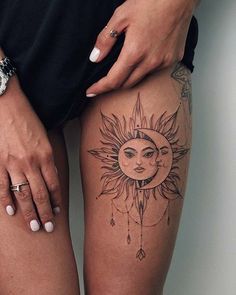 a woman's thigh with a sun and moon tattoo on her left side leg