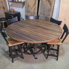 a wooden table with four chairs around it in a room filled with other furniture and items