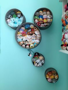 there are many stuffed animals in baskets on the wall