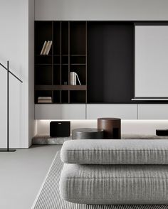 a living room filled with furniture and bookshelves next to a wall mounted tv