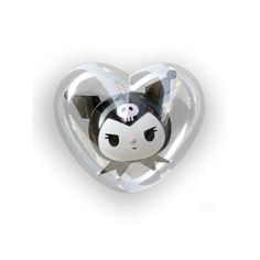 a heart shaped object with a black and white cat on it's face in the center