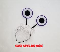 two yarn eyeballs with the words super capes and more written below them on a white background