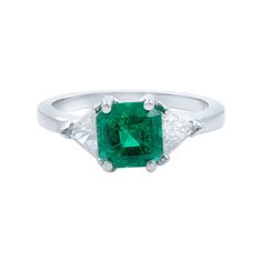 A bright vibrant crystalline green Colombian emerald with soft shouldered square emerald-cut, radiates between sparkling white trillion-cut diamonds in this classic estate jewel rendered in lustrous platinum. Timeless. Center Emerald: 1.80cts. Side Diamonds: 0.50cts (approx.) Ring Size 6.25. Total weight: 5.27 grams. Comes in a presentable gift box. Diamond Three Stone Ring, Emerald Cut Diamond Engagement, Three Stone Diamond Ring, Platinum Diamond Rings, Three Stone Diamond, Three Stone Ring, Colombian Emeralds, Three Stone Engagement, Three Stone Engagement Rings