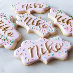 decorated cookies with the words live, love and sprinkles arranged on a table