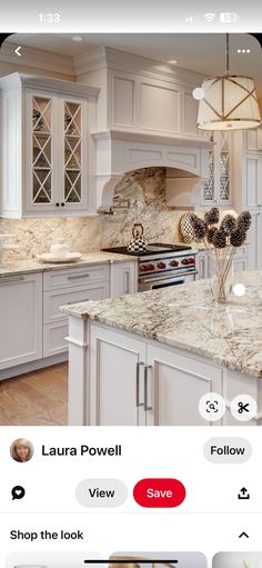 a kitchen with white cabinets and marble counter tops, along with an instagram page