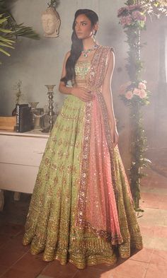 Green Lehenga and Turquoise Choli Indian Bridal Dress is a stunning attire adorned with hand-crafted details of ornaments. The shimmering details and goldwork give a glamorous touch to this perfectly stitched Bridal Lehenga Choli attire. Lehenga Choli: The choli is in an alluring turquoise color is gracefully embellished with zardosi, dabka, kundan, tilla, and goldwork. Shimmering ornaments and hanging motifs make this choli in sleeveless design, adorned with belt, a perfect choice to pair with the Bridal Lehenga. Bridal Lehenga: This Bridal Lehenga in a stunning green color is emblazoned with dabka, naqshi, mukaish, sequins, tilla, kora, Resham work, goldwork, and motifs. The Lehenga has a huge flare and is adorned with embellished borders. The Lehenga has premium net fabric. Net Dupatta: Bridal Lehenga Indian, Manish Malhotra Lehenga, Pakistani Bridal Dress, Lehenga Bridal, Pakistani Women Dresses, Indian Bridal Lehenga, Green Lehenga, Indian Bridal Dress, Indian Bridal Wear