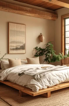 a large bed sitting in the middle of a bedroom next to a window with potted plants on it