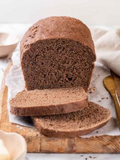 a loaf of brown bread sitting on top of a cutting board