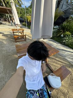 a person sitting at a table with a white object in front of them on the ground