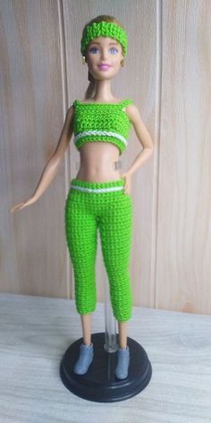 a doll is wearing green pants and a crop top