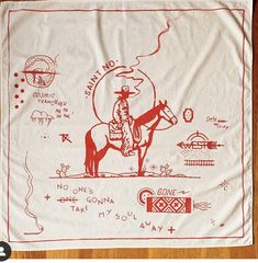 a bandana with an image of a cowboy riding a horse