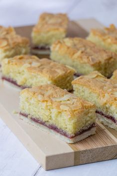 several pieces of cake sitting on top of a wooden cutting board