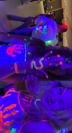 two girls with glow paint on their arms