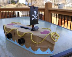 a paper bag with a pirate ship on it sitting on top of a glass table