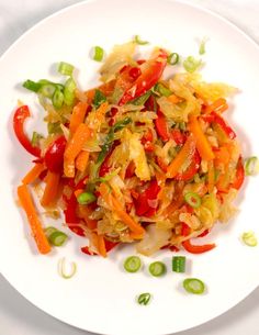 a white plate topped with vegetables on top of a table