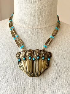 Stunning vintage Victorian Egyptian design antique brass & turquoise pendant necklace.  This necklace was hand-crafted around a beautiful brass pendant, which is a brooch with pin back still attached. The clasp is an antique 'C' clasp which dates it to the late 1800's.  The pendant has an Egyptian design and is set with turquoise glass cabochon beads. I added vintage brass chain with a geometric pattern, to which I added vintage blue glass beads from Japan. The necklace measures 18-1/2" long, wi Egyptian Design, Turquoise Pendant Necklace, Turquoise Glass, Brass Necklace, Brass Pendant, Turquoise Pendant, Brass Chain, Turquoise Beads, Vintage Brass