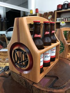 a wooden shelf holding six bottles of beer