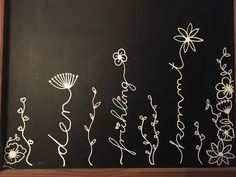 a chalkboard with flowers drawn on it