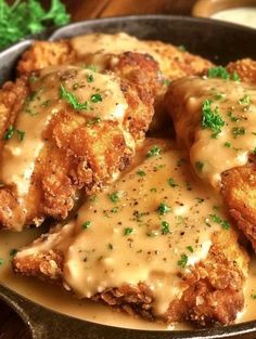 chicken with gravy in a skillet on a table