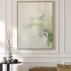 an abstract painting hangs on the wall above a table with two vases and a couch