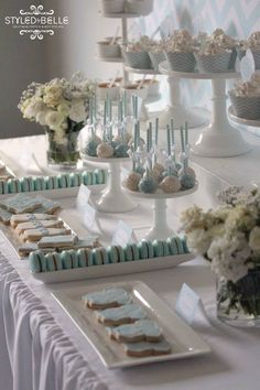 a table with desserts and cupcakes on it