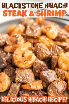 black stone hibash steak and shrimp is served on a plate with sesame seeds