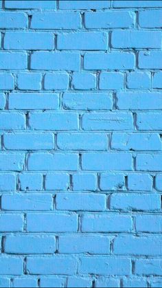 a blue brick wall that is painted bright turquoise