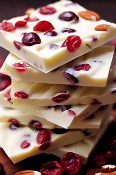 white chocolate with cranberries and almonds stacked on top of each other