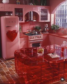 a kitchen with pink walls and flooring has a heart shaped table in the center