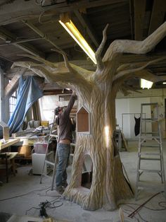 a man working on a tree in a building