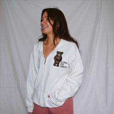 This sweet zip up is the perfect nod to being cute, trendy & loving your sisterhood! This white zip up will have our Floral Valentine's Bear embroidered front and center, with your sorority name off to the side in a stacked design in black. This zip up matches perfectly with our other Valentine's bear pieces. *Model is wearing a size XL for an oversized fit White Zipper Closure Tops For Streetwear, Casual White Sweatshirt With Zipper Closure, Sorority Names, Bear Valentines, Zip Up Sweatshirt, Sorority, Zip Ups, Valentines, Sweatshirts