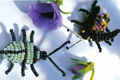 three beaded insect brooches sitting next to each other