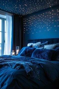 a bedroom with blue walls and stars on the ceiling, bed in front of window