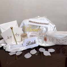 the bride's gift bag is on display with its name tags and other items