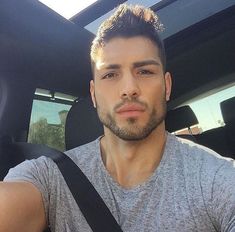 a man taking a selfie in the back seat of a car