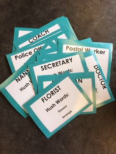 several pieces of blue and white business cards with words on them sitting on a table