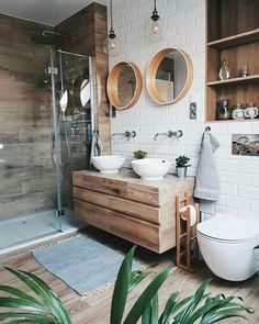 a bathroom with two sinks, a toilet and a shower in the middle of it