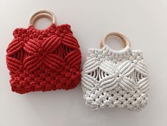 two crocheted purses sitting next to each other on a white table top