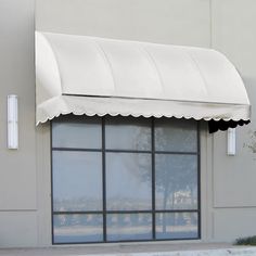 a store front with a tan awning over the window