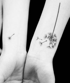 two people holding hands with tattoos on their wrists and one has a dandelion tattoo