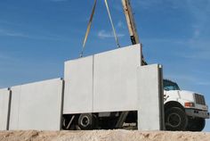 a crane is lifting concrete into place