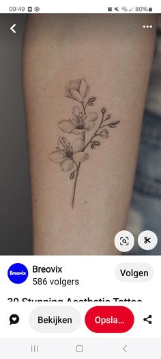 a small flower tattoo on the arm