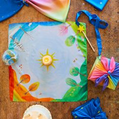 the table is covered with colorful cloths, candles and other items to decorate it