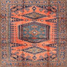 an orange, blue and pink rug with intricate designs on the center piece is shown