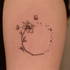 a woman's thigh with a flower and butterfly tattoo on it