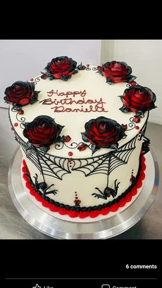 a decorated birthday cake with red roses on it