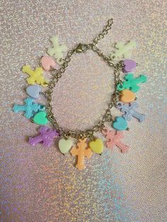 If you love wearing pastel colored jewelry, then this pastel cross charm bracelet is a great wear! With all sorts of pastel colors, this is a charm bracelet that you won't find anywhere else but here! Check out or charm bracelets section for more unique designs ❤️. *Only stainless steel materials used *Adjustable, reaches up to 6.5 inches  *All charms are randomly selected  If you have any questions, please don't hesitate to ask! We are friendly:) Visit our official website: www.yeetincolorboutique.com and follow us on Instagram: @yeetincolorboutique Pastel Things, Colored Jewelry, Jewelry Cross, Kawaii Jewelry, Cross Charms, Charm Bracelets, Pastel Colors, Jewelry Bracelets, Charm Bracelet