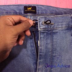 someone is trying to open the zipper on their jeans