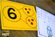 a close up of a number six on a piece of paper next to an activity book